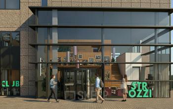 Exterior view of an office to rent at Barbara Strozzilaan 101 101, Amsterdam Zuidas, featuring glass facade and main entrance where people are entering the building.