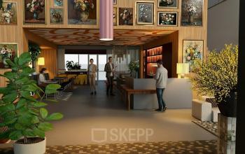 Stylish office space with art-adorned walls, where people are engaged in conversation and work activities. Ideal office space rental in Amsterdam Zuidas.