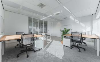Bright office space with desks and chairs available for rent at Barbara Strozzilaan 101, Amsterdam Zuidas.