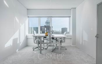 Bright office space at Barbara Strozzilaan 101, Amsterdam Zuidas, featuring large windows with a city view and modern furniture. Ideal for those seeking office space rental in a vibrant location.