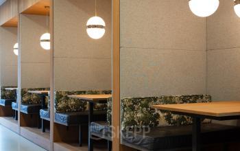 Cozy furnished workspace at Barbara Strozzilaan 101 in Amsterdam Zuidas featuring stylish booths for collaborative or independent work, ideal for office space rental.