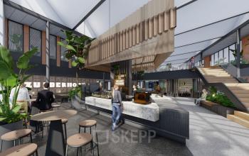 Modern office space in Amsterdam Zuidas with a spacious open floorplan, stylish furniture, and several people engaged in work activities. An ideal choice for office space rental at Jachthavenweg 109.