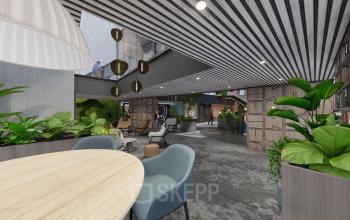 Modern office space in Amsterdam Zuidas with stylish furnishings, plants, and people engaged in a meeting, suitable for office space rental.