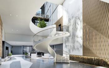 Stylish modern office entrance at Claude Debussylaan 80-134, Amsterdam Zuidas, featuring a sleek spiral staircase and natural lighting. Perfect location for office space rental.