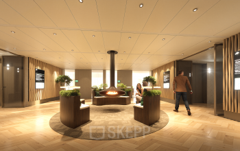 Modern office interior at Claude Debussylaan 80-134 in Amsterdam Zuidas with stylish seating and a central fireplace, ideal for rent office space.