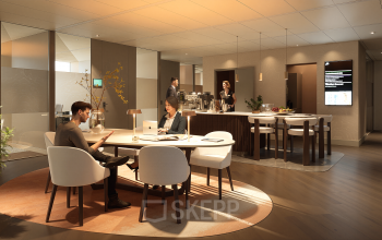 Modern furnished workspace with people engaged in business activities, including meetings and discussions, ideal for office space rental at Claude Debussylaan 80-134, Amsterdam Zuidas.