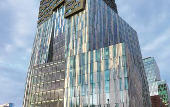 Modern glass office building in Amsterdam Zuidas, featuring a striking facade at Claude Debussylaan 80-134, suitable for office space rental.