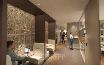 Modern office space at Claude Debussylaan 80-134 in Amsterdam Zuidas featuring stylish furnishings with individuals engaged in collaborative discussions and laptop work. Ideal for office space rental.