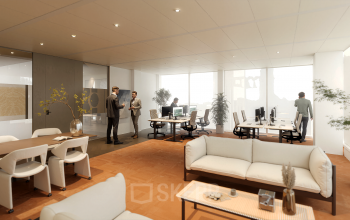 Modern office space at Claude Debussylaan 80-134 in Amsterdam Zuidas with people engaging in meetings and working at desks. Ideal for office space rental.