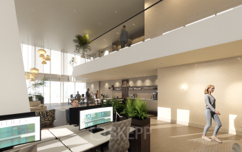 Modern office space for rent at Claude Debussylaan 80-134, Amsterdam Zuidas, featuring stylish workstations and a lounge area. People are engaging in collaborative work activities.