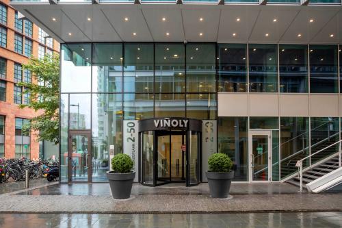 Entrance of an office building at Claude Debussylaan 10 in Amsterdam Zuidas, featuring a glass facade and revolving door.