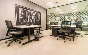 Spacious and modern office to rent in Amsterdam Zuidas at Gustav Mahlerplein. Features contemporary furnishings and a unique wall design, ideal for team collaborations or meetings.