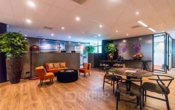 Modern office space in Amsterdam Zuidas at Claude Debussylaan 7-29, featuring stylish furniture and vibrant decor, ideal for office space rental.