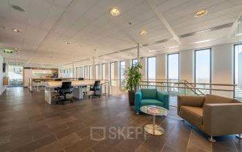 Spacious office space rental at Gustav Mahlerplein 109-115, Amsterdam Zuidas, featuring modern furnishings and ample natural light.