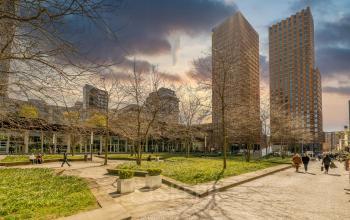 Exterior view of office space rental located at Gustav Mahlerplein 109-115 in Amsterdam Zuidas, with modern buildings and a landscaped plaza.