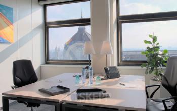 Bright office space at De Keyserlei 58-60 in Antwerp Centre featuring large windows with city views and modern furnishings, ideal for office space rental.
