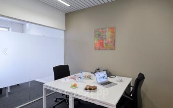 Modern furnished office for rent at Lange Lozanastraat 142, Antwerp Center, featuring a bright workspace with chairs and a desk, ideal for professionals looking for office space rental.