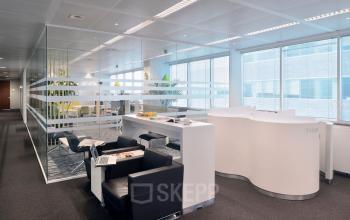 Modern office space in Antwerp with sleek furniture and glass partitions, ideal for business activities. Find office space rental opportunities here.