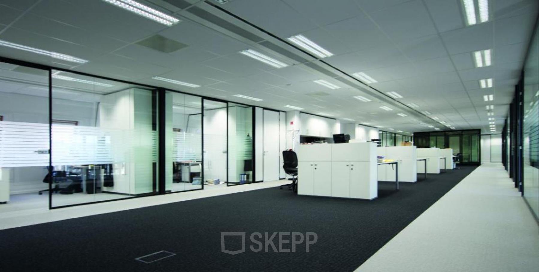 Modern office space at Brusselstraat 59, Antwerpen Sint-Andries, featuring spacious workstations, glass partitions, and ample lighting. Ideal for office space rental.