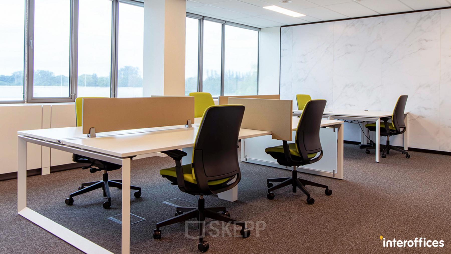 Modern office to rent with multiple workstations, ergonomic chairs, and large windows located at Nijverheidsstraat 70, in Antwerp Wommelgem, Antwerp.