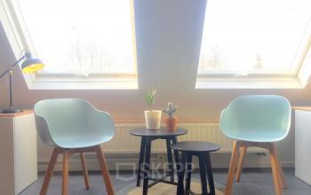 Bright office with skylights at Grote Hondstraat 44, Antwerp Zurenborg, featuring modern chairs and small tables, ideal for office space rental.
