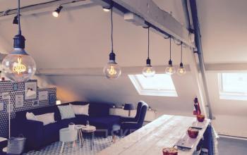 Chic workspace in Antwerp Zurenborg with modern lighting, comfortable seating, and stylish decor, located at Grote Hondstraat 44.