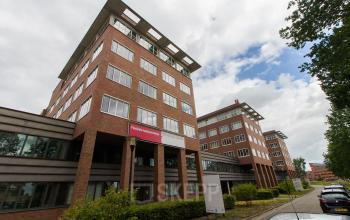 Modern office space rental at Het Rietveld 55A in Apeldoorn with a brick exterior and large windows.