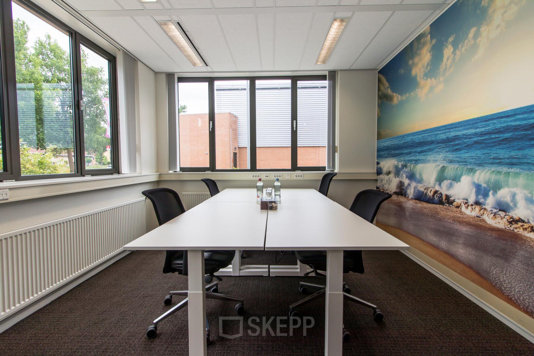Modern office space rental at Het Rietveld 55A, Apeldoorn, with a large window, white walls, a conference table, and vibrant ocean-themed artwork.