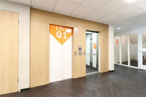 Interior view of an elevator lobby at Prins Willem-Alexanderlaan 401, Apeldoorn, suitable for office space rental, showcasing a clean and modern design.