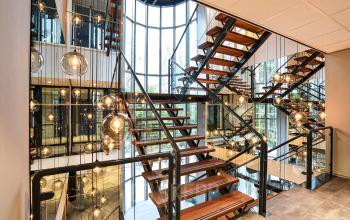 Modern multi-level staircase with stylish lighting at the office space in Landdrostlaan 51, Apeldoorn, ideal for office space rental.