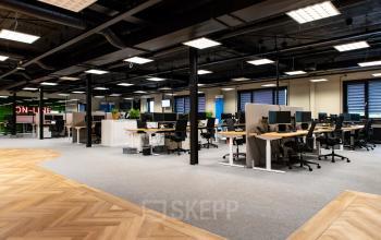Spacious office at Landdrostlaan 51, Apeldoorn, featuring a modern open floorplan with multiple workstations. Ideal for those looking to rent office space in a dynamic environment.