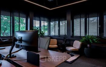 Modern office space at Lange Amerikaweg 55-61, Apeldoorn featuring workstations with computers, comfortable seating, and abundant natural light from large windows, suitable for office space rental.