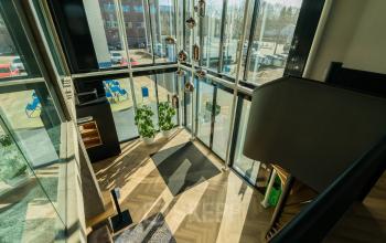 Bright office space with modern furnishings and large windows, located at Prins Willem Alexanderlaan 701, Apeldoorn, ideal for office space rental.