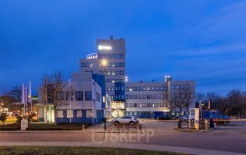 Exterior view of office building at Prins Willem Alexanderlaan 701, Apeldoorn, featuring multiple stories and modern design elements. Ideal for those looking for office space rental in a prominent location.