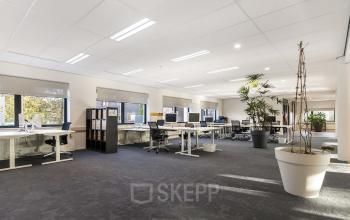 Spacious office interior at Waterloseweg 7a, Apeldoorn with modern furnishings, large desks, and abundant natural light, ideal for open floorplan office space rental.