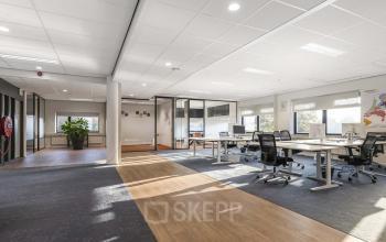 Bright and spacious office interior at Waterloseweg 7a, Apeldoorn featuring modern workstations with natural light streaming through large windows, ideal for office space rental.
