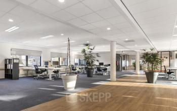 Spacious open-plan office interior at Waterloseweg 7a, Apeldoorn with modern furnishings and abundant natural light, perfect for office space rental.