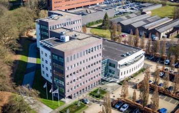 Aerial view of an office complex at Schumanpark 9, Apeldoorn, showcasing multiple modern buildings available for office space rental.