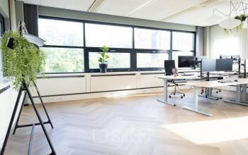 Bright office space in Schumanpark 9, Apeldoorn, featuring modern desks and large windows, perfect for those seeking office space rental.