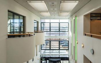 Interior view of Schumanpark 9 in Apeldoorn showcasing natural light filling the office space available for rent.