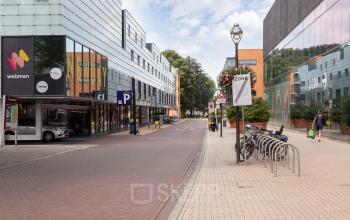 Street view of office buildings located at Roggestraat 111 in Apeldoorn, showcasing the modern exteriors suitable for office space rental.