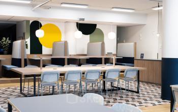 Modern office space rental at Jansbuitensingel 30 in Arnhem Centrum with colorful acoustic panels and contemporary furniture.