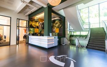 Modern office to rent at Jansbuitensingel 7 in Arnhem Centrum, featuring a stylish reception area with natural light and contemporary décor.