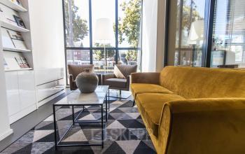 Furnished office space at Jansbuitensingel 7 in Arnhem Centrum with modern seating and large windows, ideal for rent office space seekers.