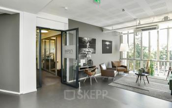 Bright office space with large windows and modern furnishings at Jansbuitensingel 7, perfect for rent office space in Arnhem Centrum.