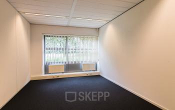 Bright and modern office space rental at Meander 251, Arnhem IJsseloord with large windows and carpeted floors.