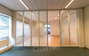 Spacious and well-lit office space rental at Meander 251 in Arnhem IJsseloord with modern glass partitions and neutral decor.