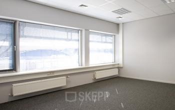 Interior view of an empty office space at Driepoortenweg 24, Arnhem Oost, Arnhem with large windows and ample natural light.