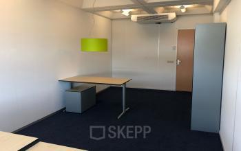Office to rent at Simon Stevinweg 27, Arnhem Oost, Arnhem featuring minimalist design with modern furniture, including desks, chairs, and a striking green lamp.