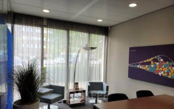 Interior of a furnished office space located at Meester D.U. Stikkerstraat 11, Arnhem Zuid, Arnhem, featuring seating area, modern decor, natural light from large windows.
